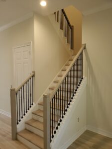 Timeless staircase design tips from CFL Custom Carpentry, blending warm wood tones with modern ironwork details.