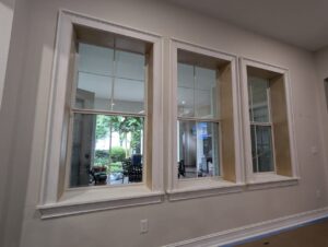 Detailed window casing installation in progress, showcasing CFL Custom Carpentry’s craftsmanship and how seasonal home maintenance tips include checking and updating interior trim for a refreshed look.