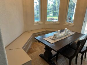 Built-in banquette seating wrapping around a dining nook, combining comfort with space-saving carpentry, crafted by CFL Custom Carpentry