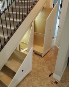 Smart under-stair pull-out drawers designed by CFL Custom Carpentry, showcasing innovative space-saving carpentry with custom-built storage compartments that slide seamlessly beneath the staircase.