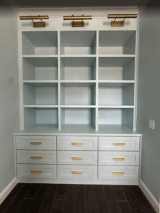 Built-in cabinetry with drawers and open shelving finished in soft blue tones, an example of smart space-saving carpentry by CFL Custom Carpentry.