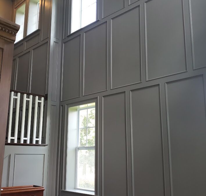 Floor-to-ceiling wall paneling by CFL Custom Carpentry, a standout feature that ties into seasonal home maintenance tips for updating interior aesthetics and insulation.